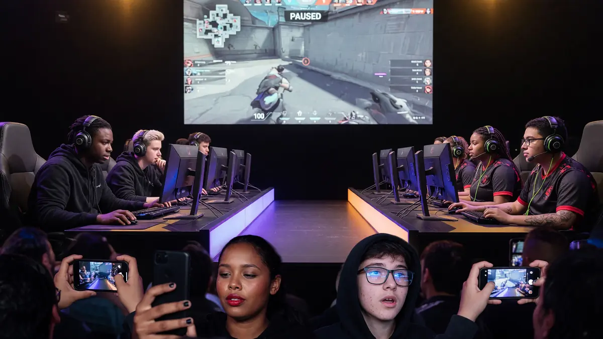 Analyst desk with multiple monitors showing match stats and a notepad