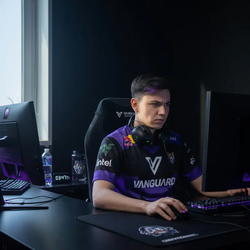 Player at a setup station with window light falling across the keyboard